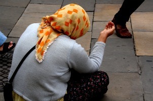 Woman sitting on a sidewalk